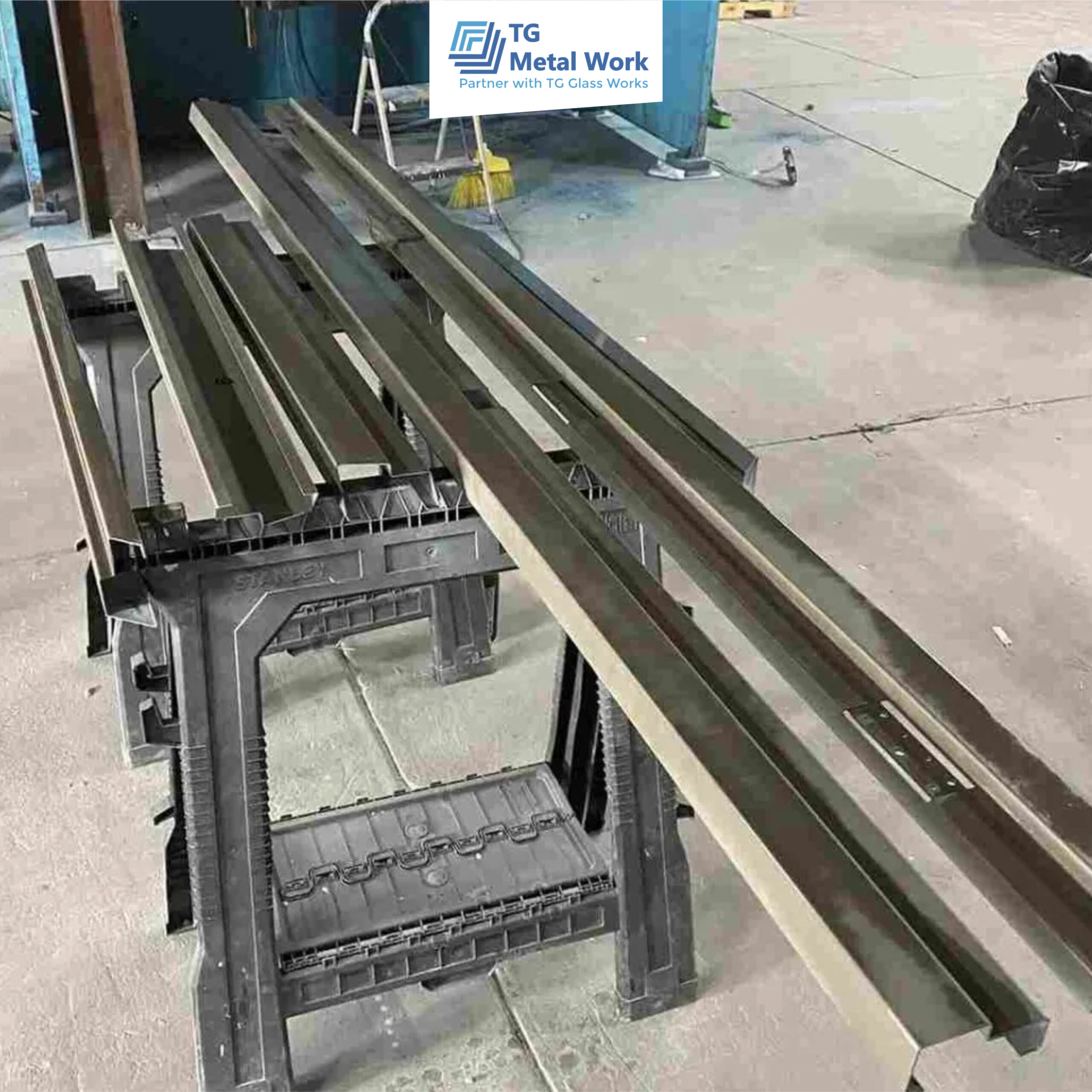 Precision-cut metal profiles prepared in a workshop by TG Metal Work for fabrication and installation.