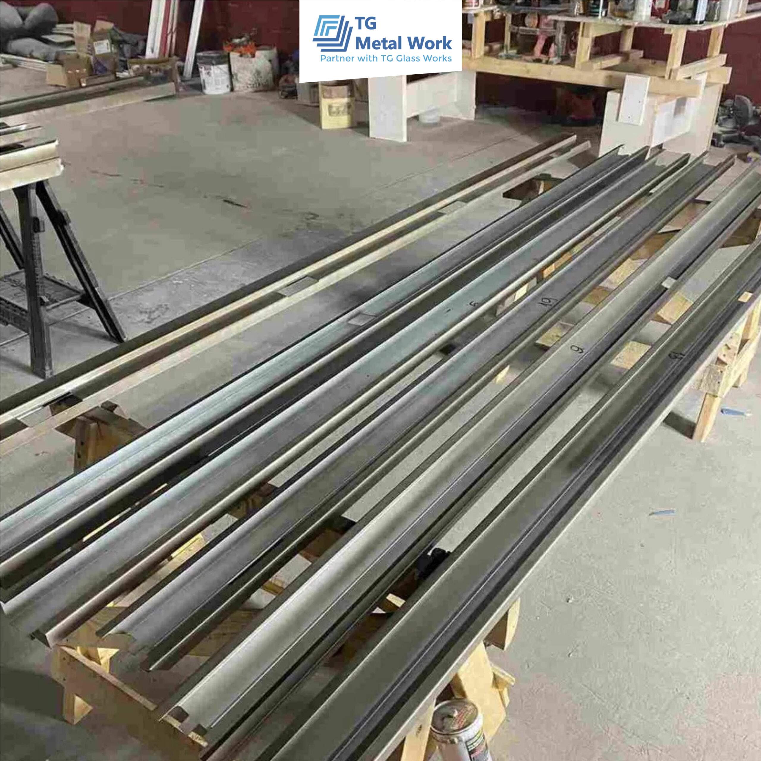 Precision-cut metal profiles prepared in a workshop by TG Metal Work for fabrication and installation.